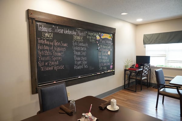 Chalkboard menu in a dining area with tables