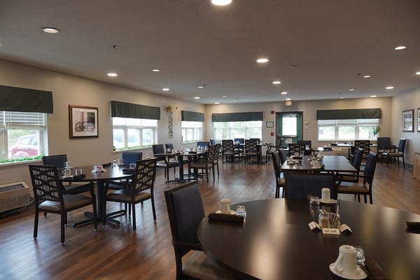 Dining area with tables and chairs set up for residents
