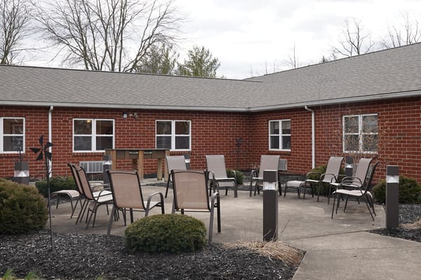 Outdoor seating area with chairs and landscaping