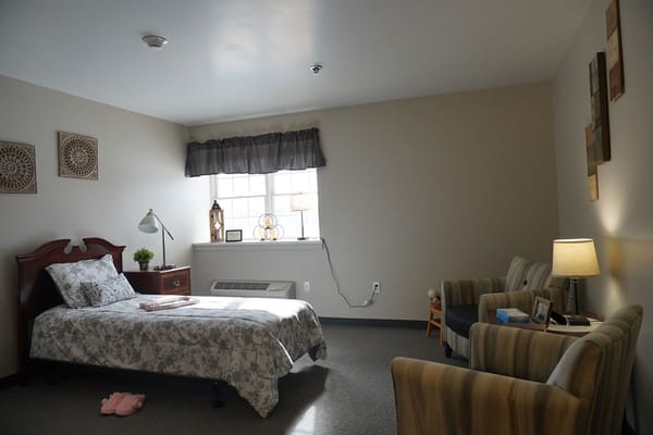 Cozy resident room with bed and seating