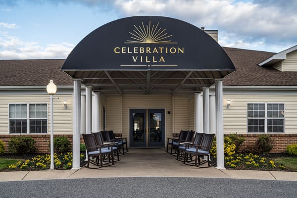 Front entrance with rocking chairs and a canopy at Celebration Villa
