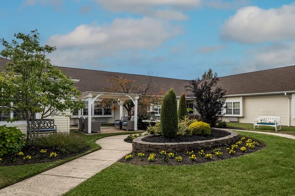Peaceful courtyard with flower beds and seating area.