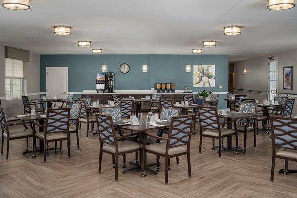 Dining room with neatly set tables and chairs