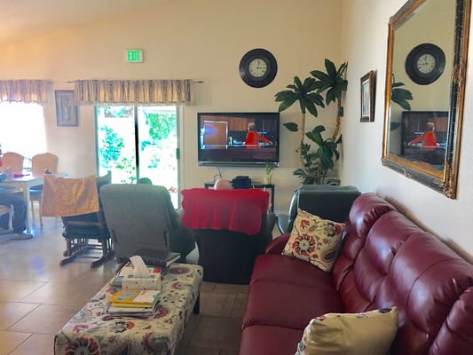 Cozy common area with seating, television, and outdoor view.