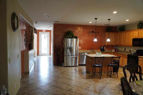 Bright kitchen area with modern appliances and seating
