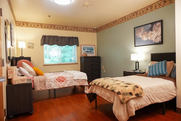 Comfortable resident room with two beds and decor