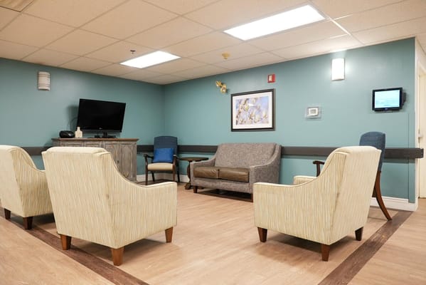 Interior common area with seating in a nursing home