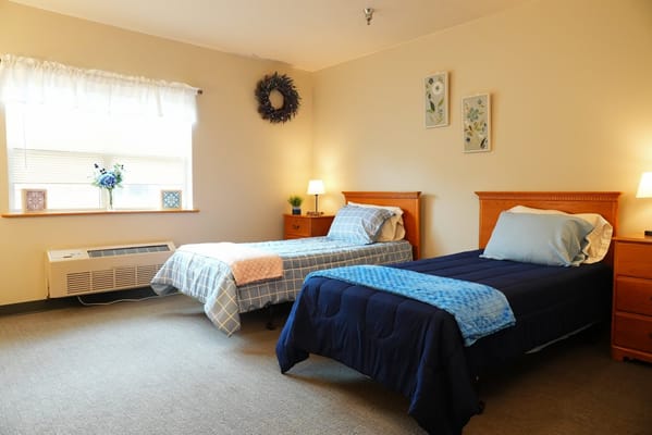 Bright interior of a shared resident room with two beds