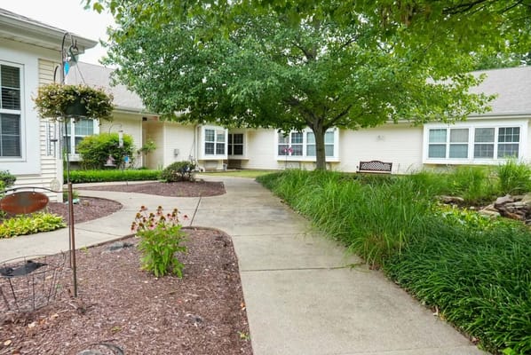 Pathway surrounded by greenery in a senior living outdoor space