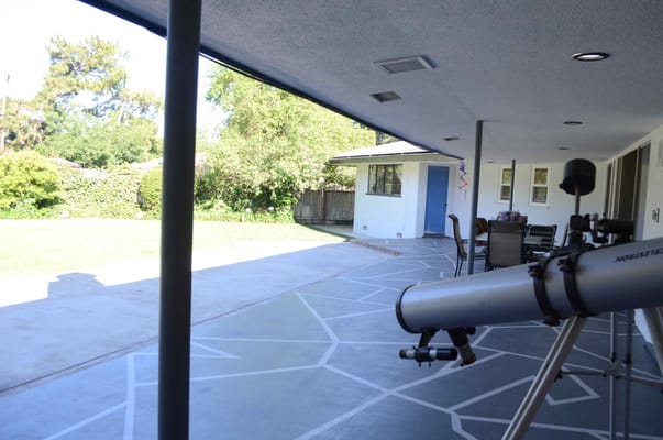 Outdoor space with a telescope and patio area