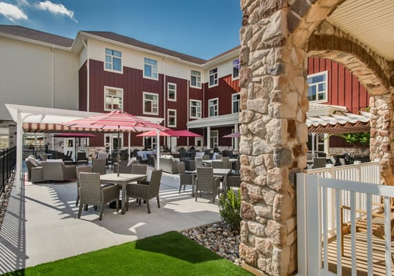 Outdoor seating area with tables and umbrellas