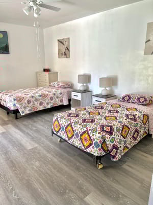 Bright, inviting room with twin beds and decor