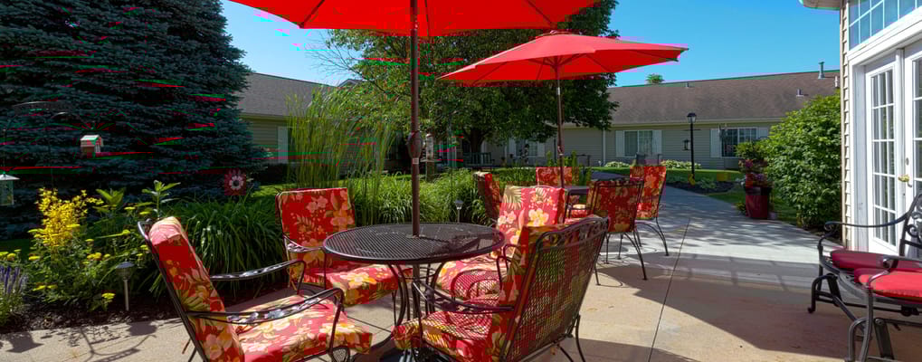 Outdoor seating area with bright umbrellas and flowers