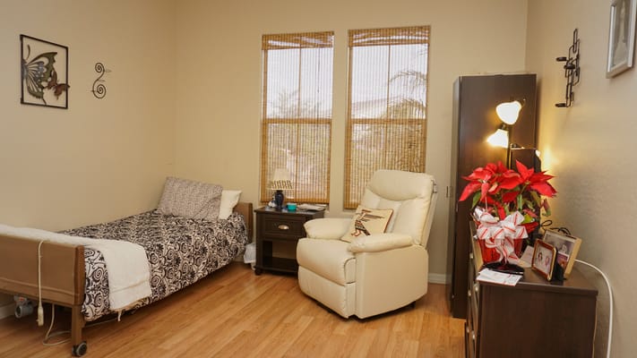 Cozy bedroom with a bed, armchair, and decor.