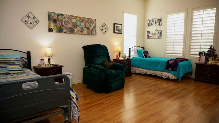Cozy bedroom with two beds and a recliner