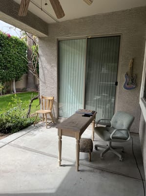 Patio with a wooden table and chairs at Emma Assisted Living Home