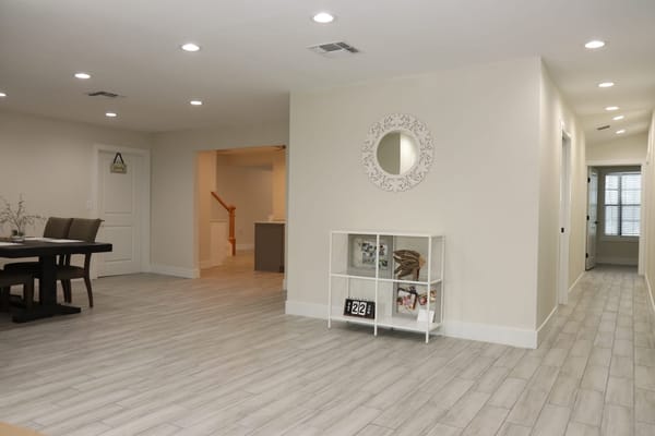 Bright common area with dining table and decorative shelf