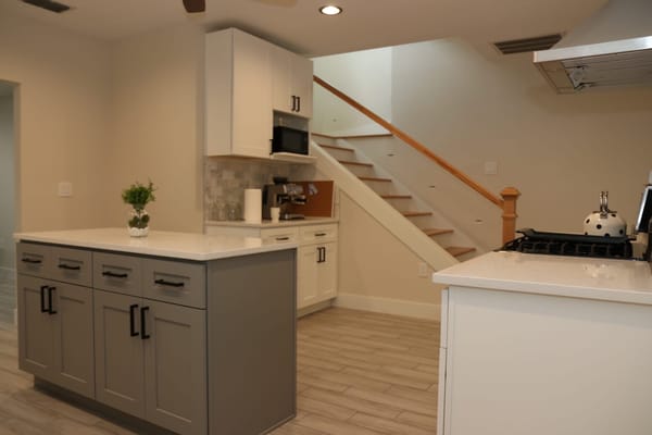 Contemporary kitchen with an island and stairway