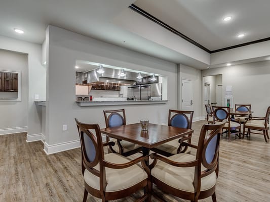 Common area with tables and chairs in a dining setting