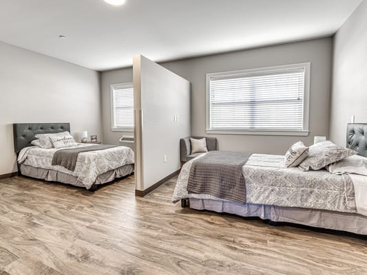 Shared bedroom with two beds at Iris Memory Care of Nichols Hills