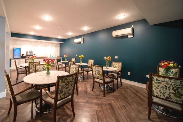 Bright dining area with flower arrangements and tables