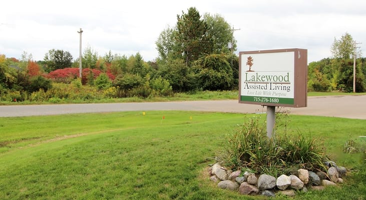 Exterior view of Lakewood Assisted Living sign and landscape