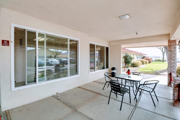 Outdoor patio seating area with tables and chairs