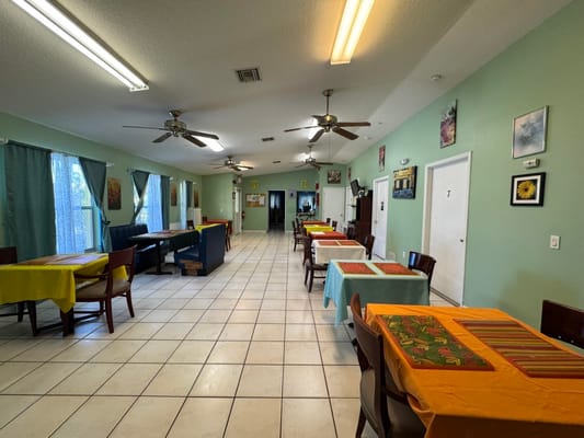 Interior dining area with tables and colorful tablecloths