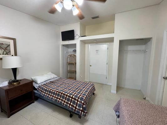 Interior of a private resident room with bed and nightstand
