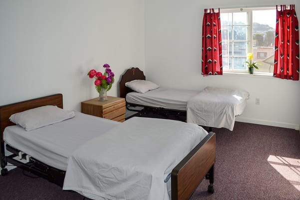 A shared room with two beds and a window