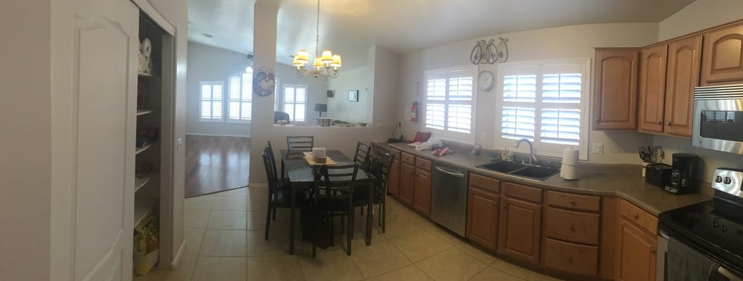 Spacious kitchen with a dining table and modern appliances.