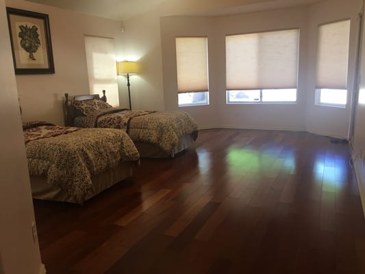 Cozy bedroom with two twin beds and window shades