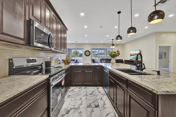 Well-equipped kitchen with granite countertops and stainless-steel appliances