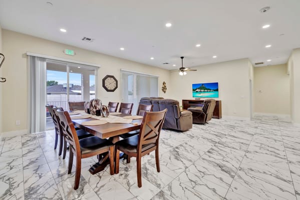 Spacious common area with dining table and seating