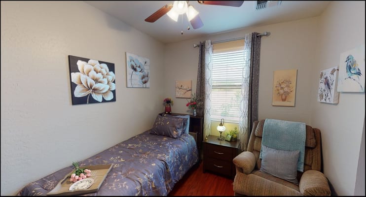Cozy resident room with floral decor and a recliner