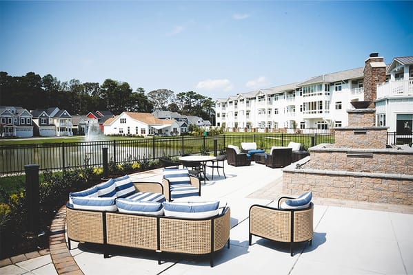 Outdoor patio seating overlooking a pond