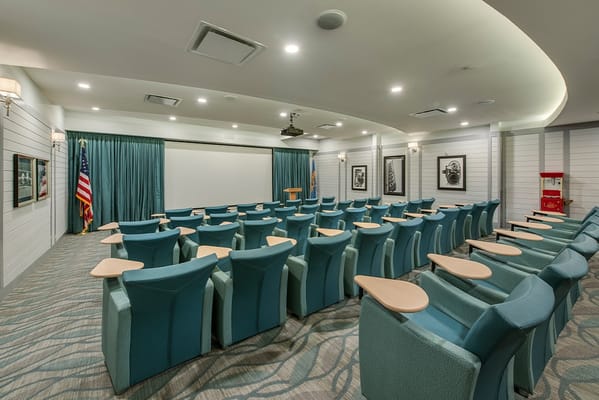 Seating area in the theater room with a projector screen