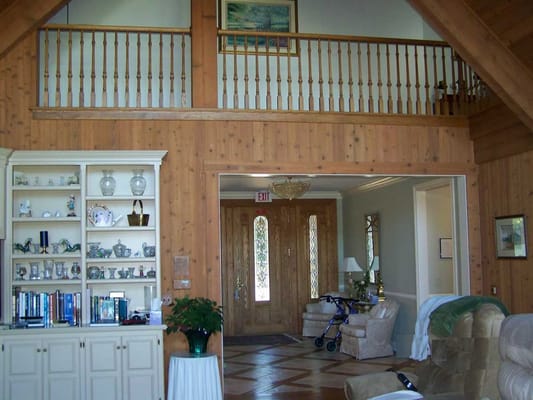 Cozy lobby area with wooden walls and decorative shelf