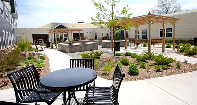 Outdoor courtyard with seating and landscaping at Valparaiso Senior Village.