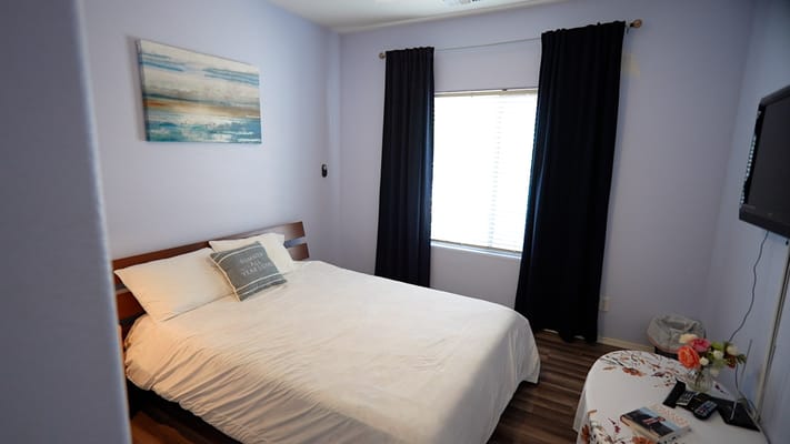 Cozy bedroom with a bed, window, and decorative elements