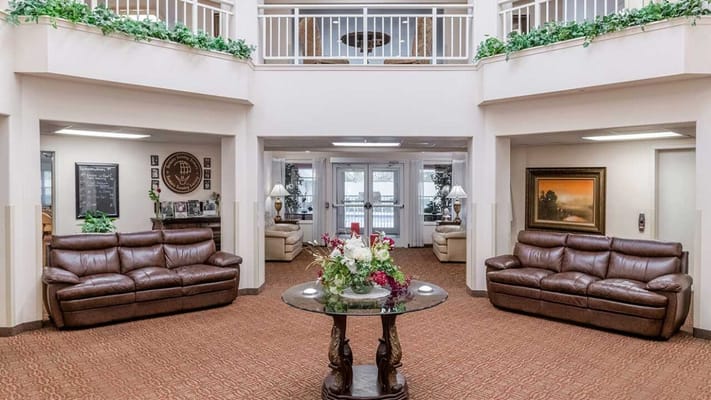Spacious lobby with comfortable couches and a floral centerpiece