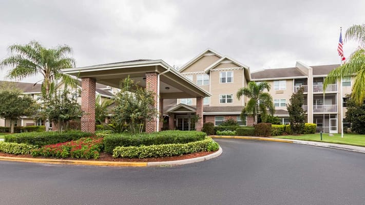 Entrance view of Sky Active Desoto Beach Club with landscaped surroundings.