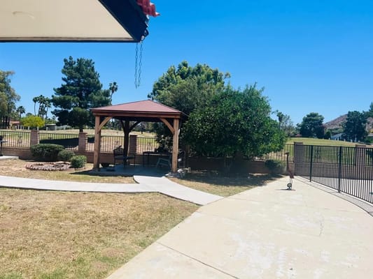 Outdoor seating area with a gazebo and landscaped garden