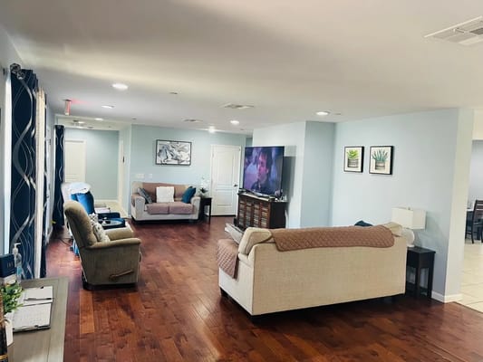 Bright common area with cozy seating and TV