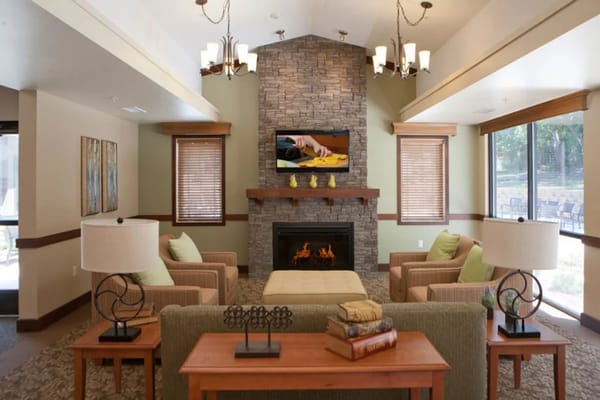 Inviting living room with stone fireplace and comfortable seating