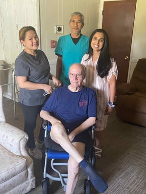 Staff assisting a resident in a facility room