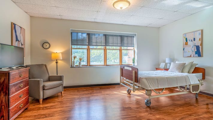 Bright private resident room with wooden flooring