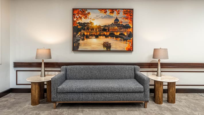 Interior lounge area with a grey couch and art