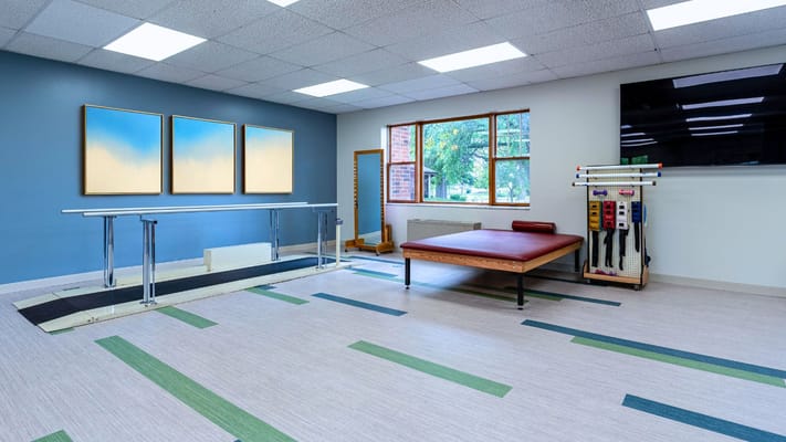 Physical therapy space with equipment and art