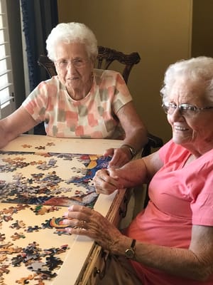 Two residents working on a jigsaw puzzle together